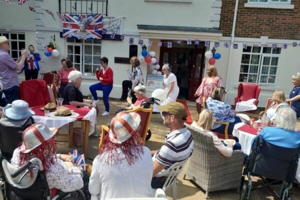 Crowd of event attendees enjoying the Jubilee celebrations at Sundridge Court Care Home