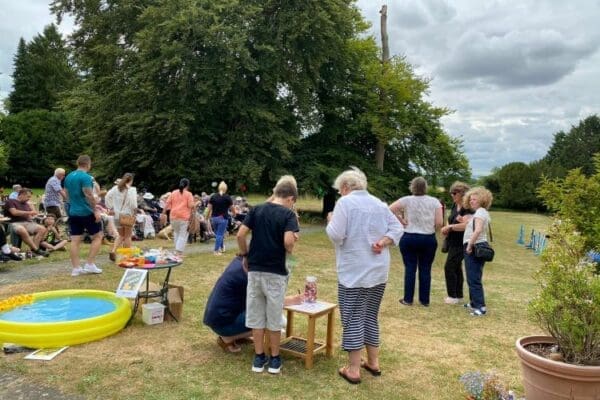 Visitors to the Huntercombe Hall Summer Fete 2022 enjoying the events activities