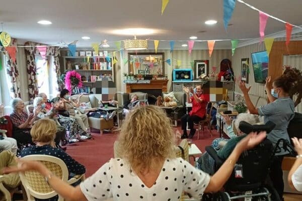 Home of Compassion residents chair dancing