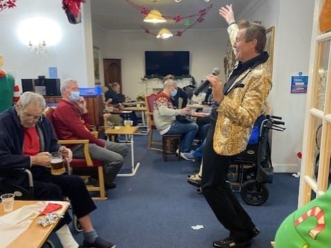 Male entertainer singing to the Sundridge Court residents