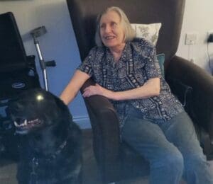 Belmont House resident enjoying a visit from PAT Dog Joe