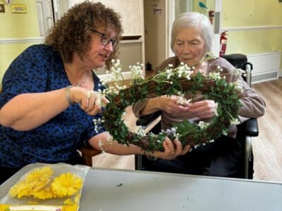 Leigh working with one of the residents on the wreath design