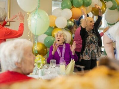 Beechwood Park Care Home Refurbishment Launch Event April 2024 - Residents celebrating with balloons and dancing